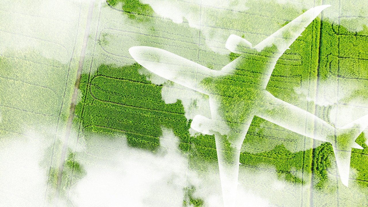 A figure of an airplane over a green field as a concept of sustainable aviation.