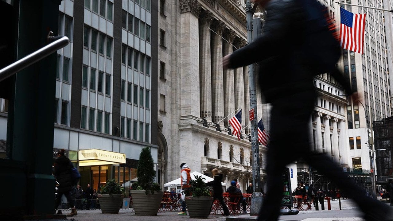 A blurred person in black clothing in the foreground walks past the New York Stock Exchange (NYSE) on November 20, 2025 in New York City. Stocks surged over 500 points after Nvidia on Wednesday reported fiscal third-quarter earnings that beat expectations.