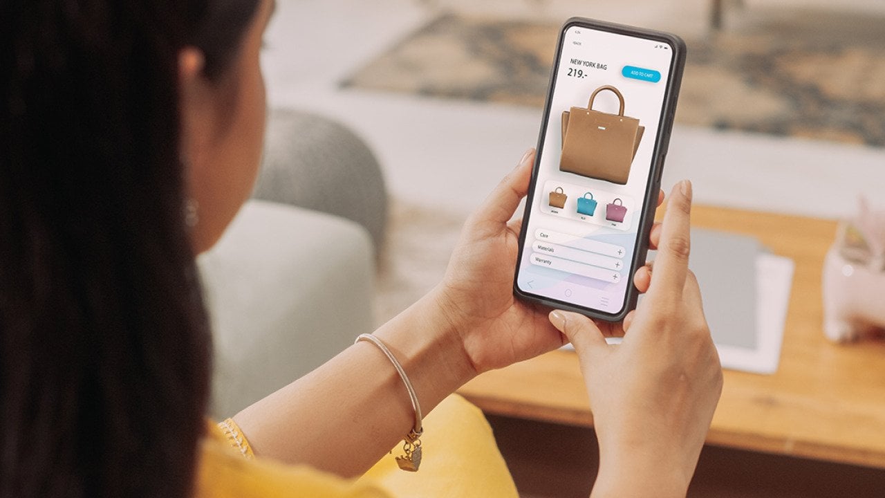 A woman browsing a shopping page on her smartphone.