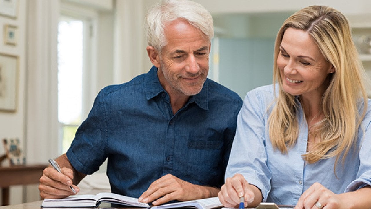 A man and a woman looking at financial documents.