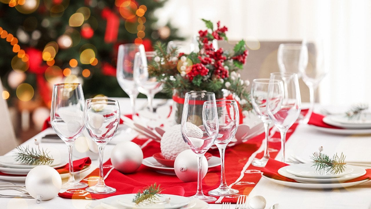 A beautiful Christmas dinner table setting with red and white motifs.