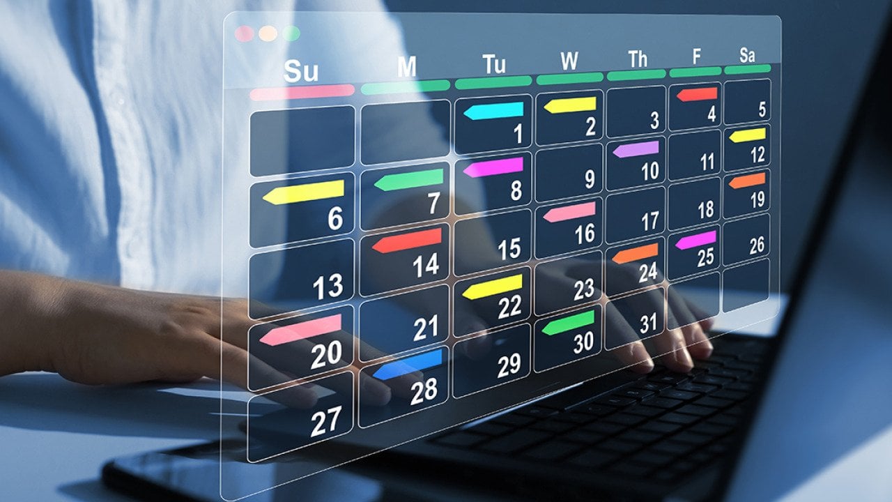 Person using a laptop with graphics of a digital calendar.