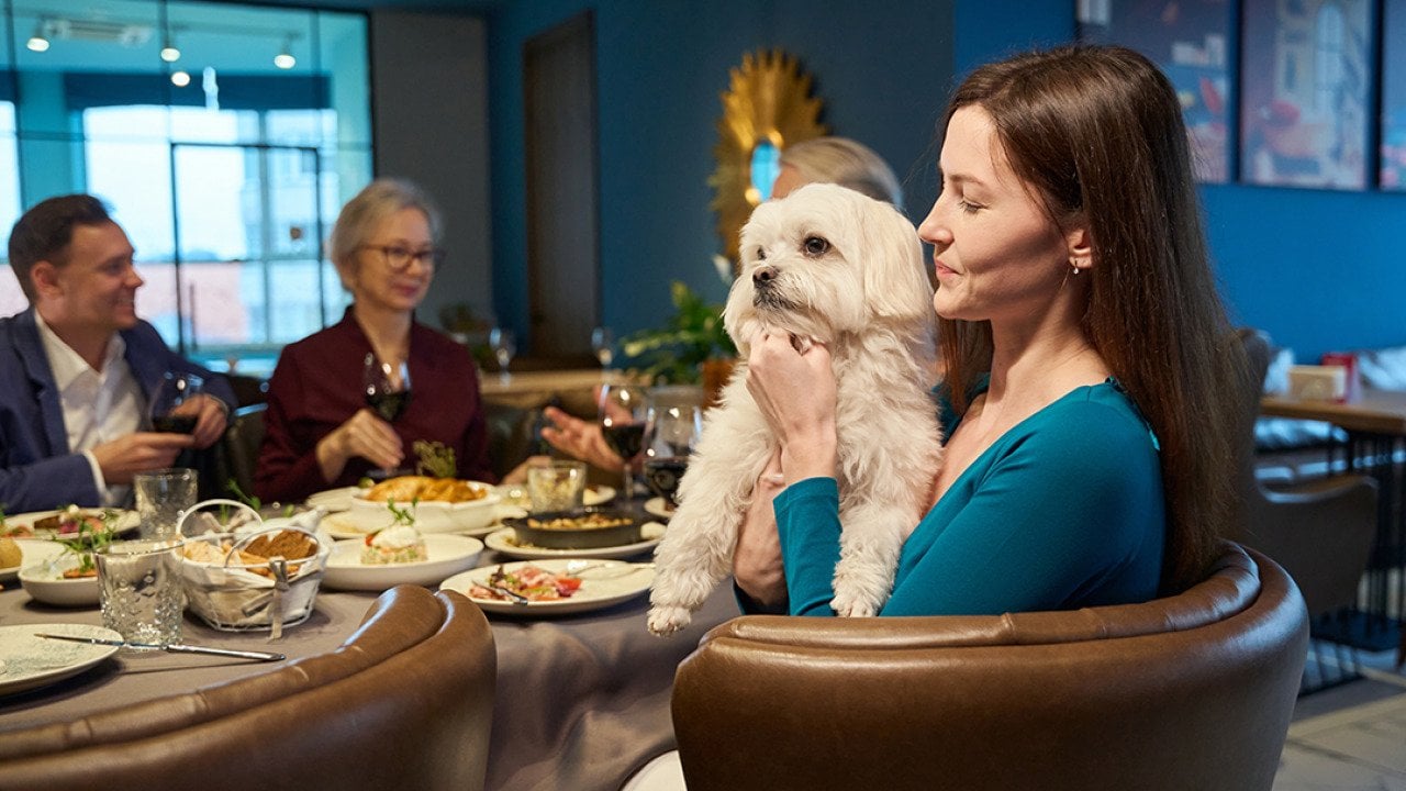 A woman holding her dog during family celebration of New Year's Eve.