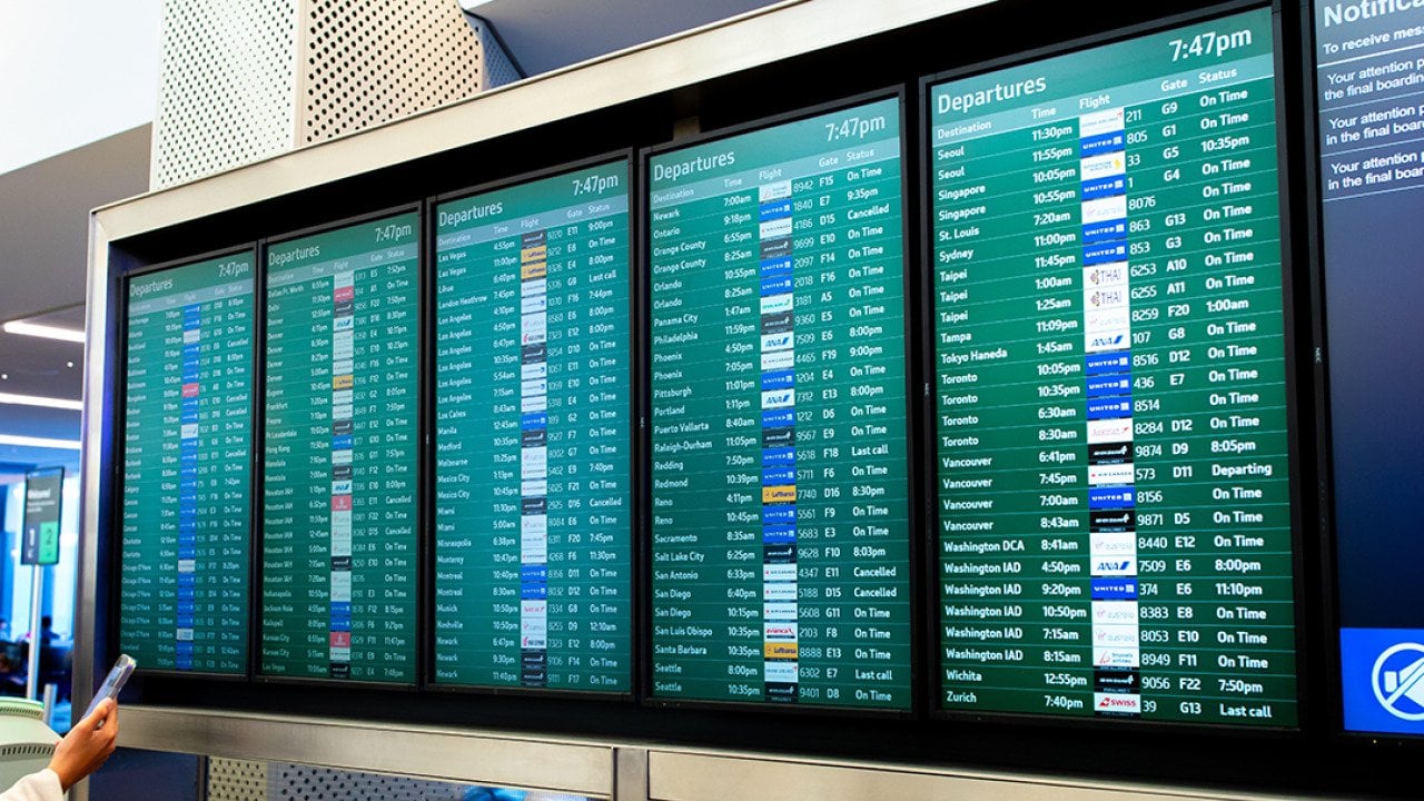 A flight arrival and departure board at an airport.