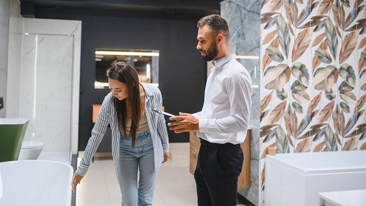 A young couple choosing new bathroom furniture.
