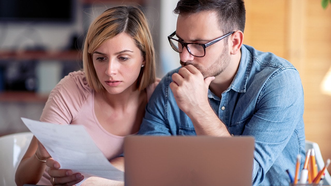 A couple analyzing finance documents.