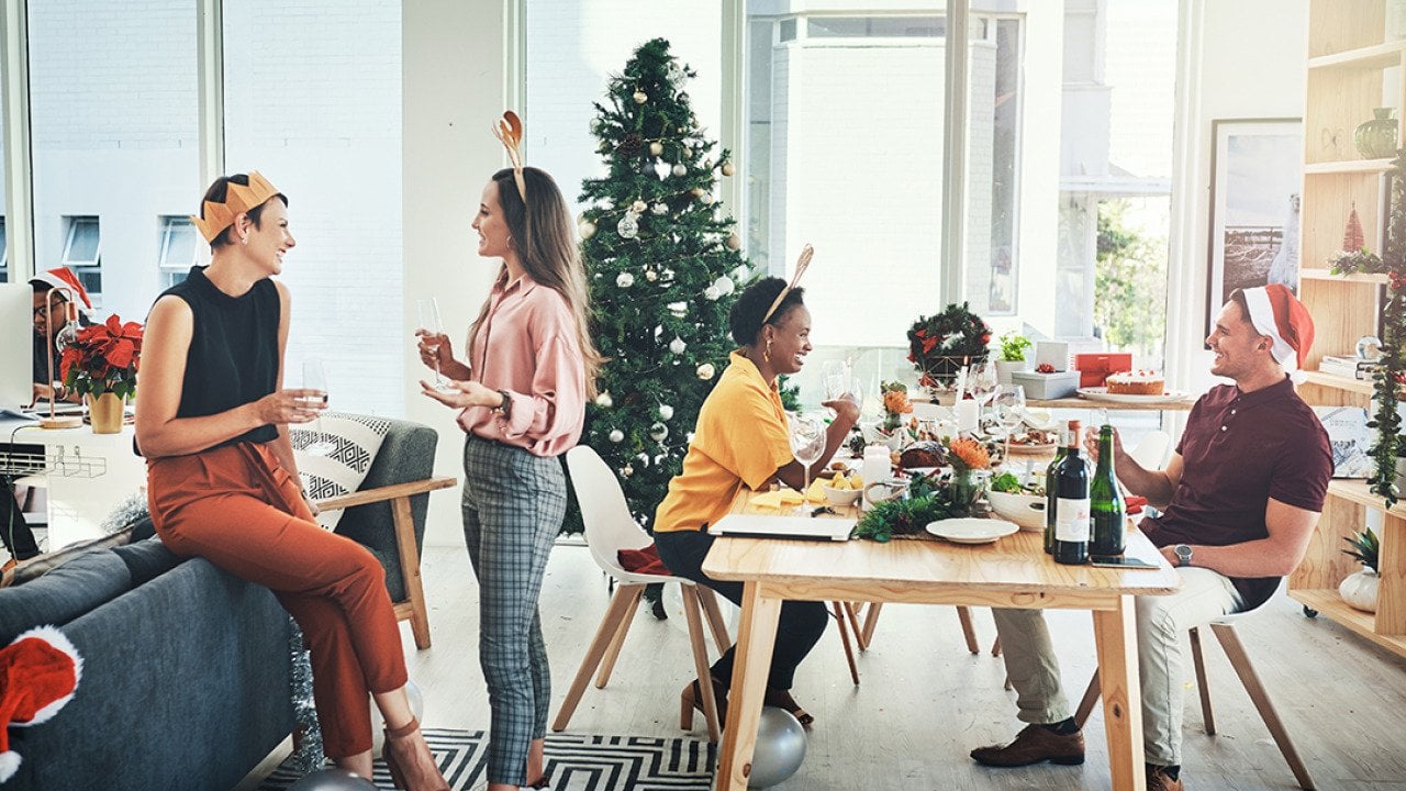 Coworkers having a Christmas party in their office.