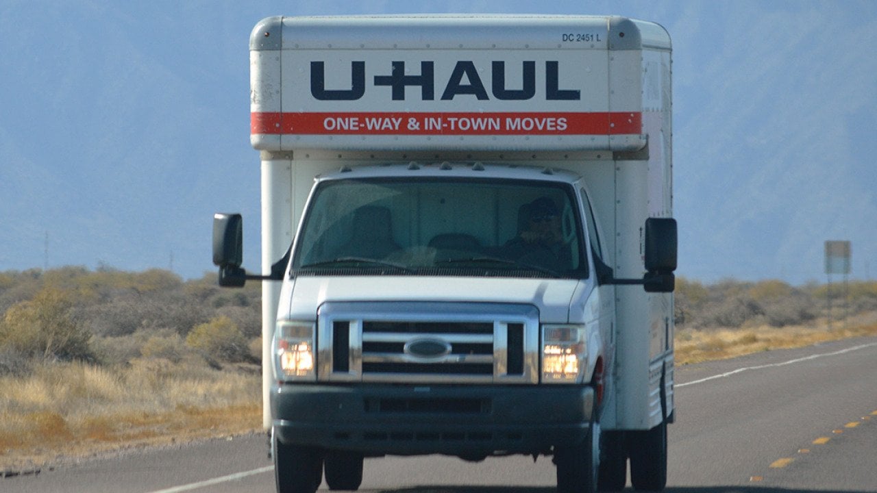 A U-Haul truck on a highway.