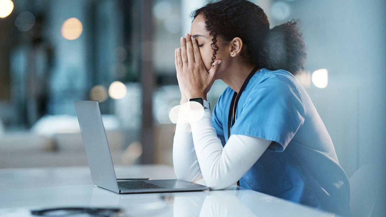 A hospital nurse experiencing burnout at work.