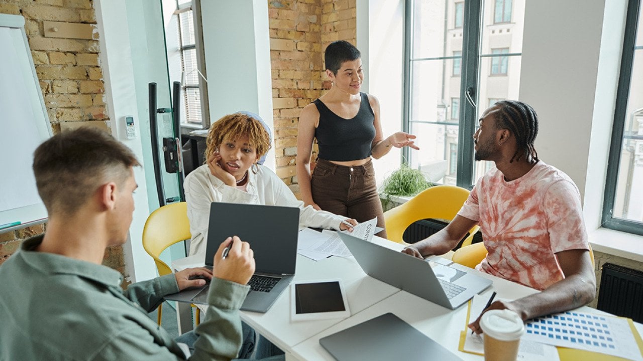 A diverse Gen Z business team in a meeting room.