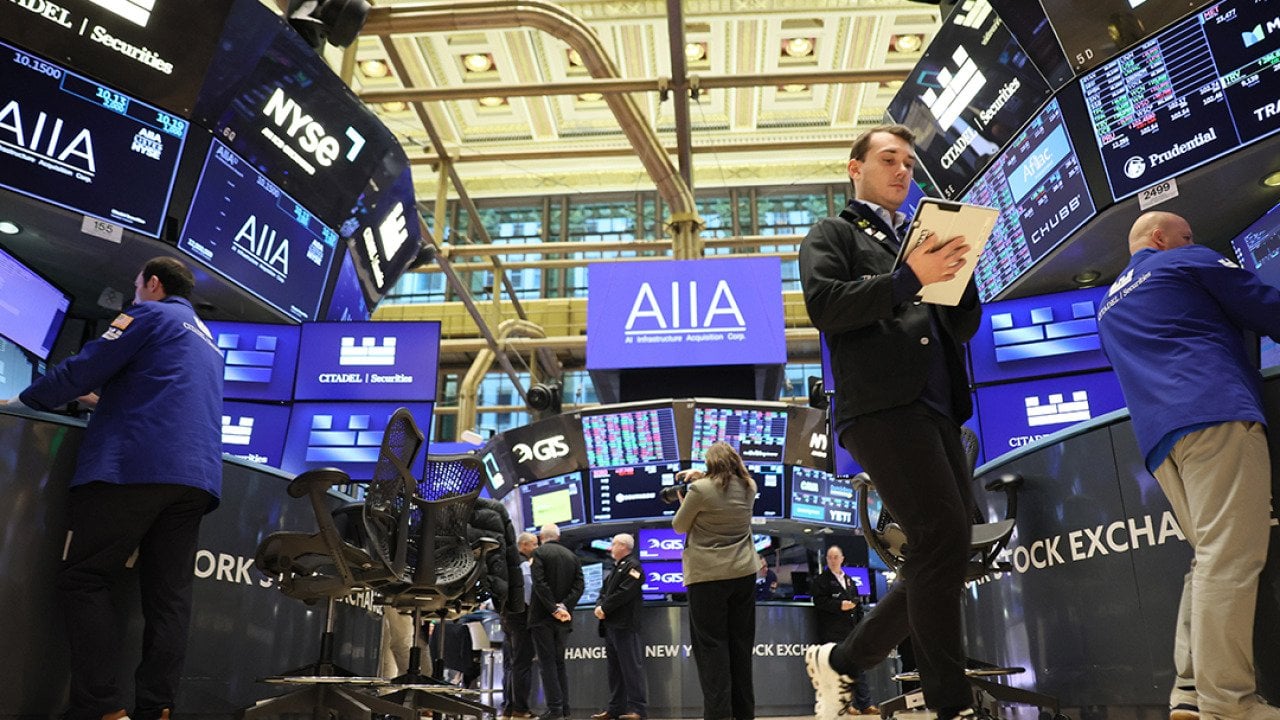 Traders work on the floor of the New York Stock Exchange during morning trading on November 19, 2025 in New York City.
