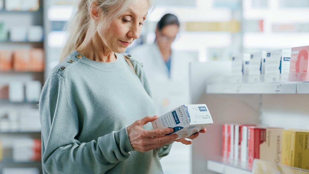 A senior woman buying a product at the pharmacy.