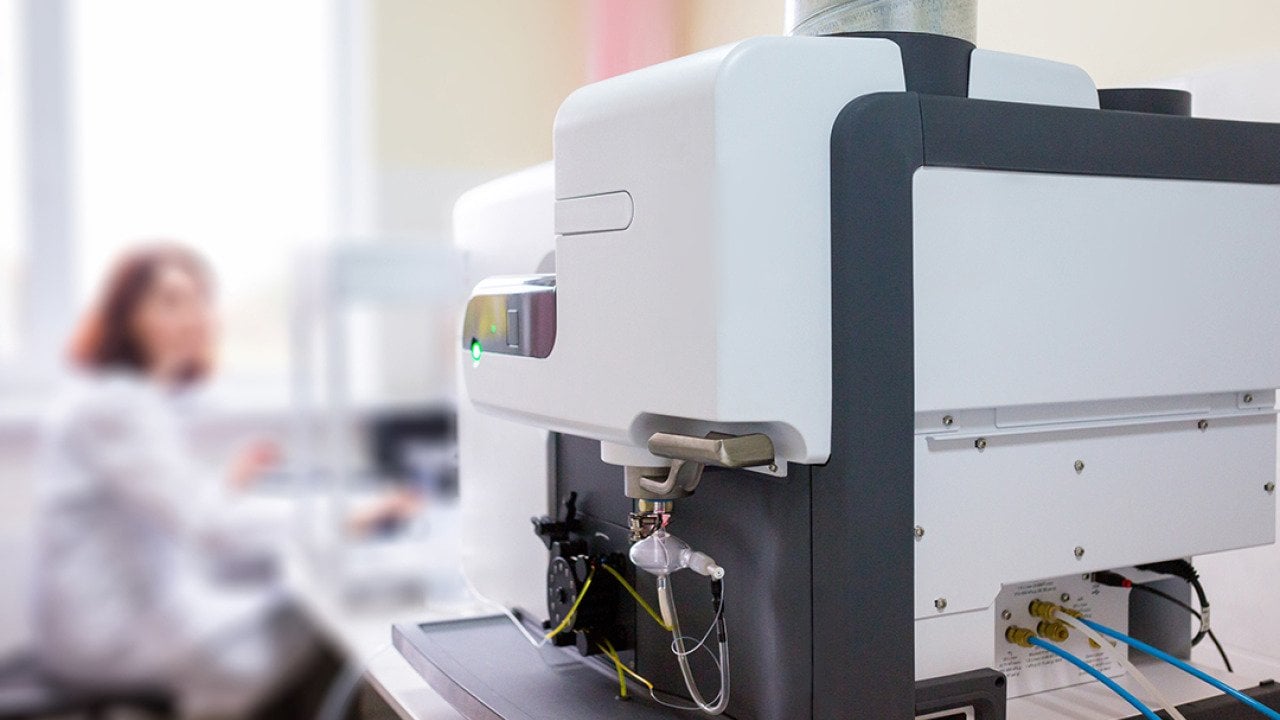 A focus on a microwave plasma atomic emission spectrometer (MPAES) a scientist is working with in a laboratory.