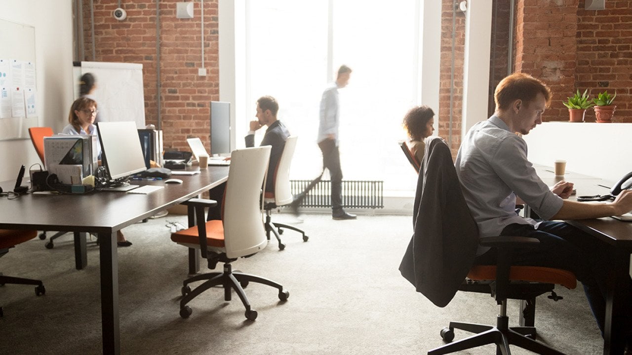 A busy team of employees around a modern office.