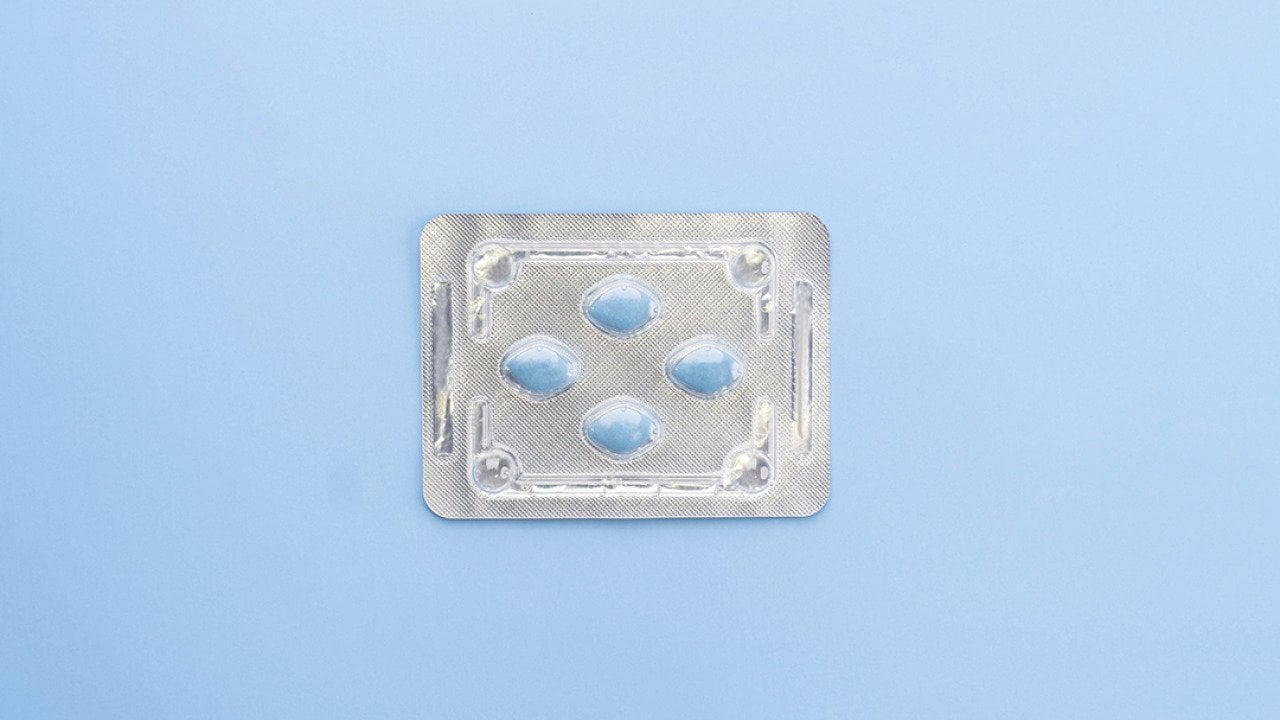A blister package of Sildenafil, also known as Viagra, on a blue background.