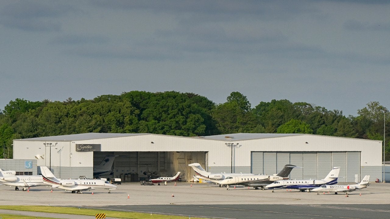 Private jets lined up outside at an airport terminal in Baltimore.