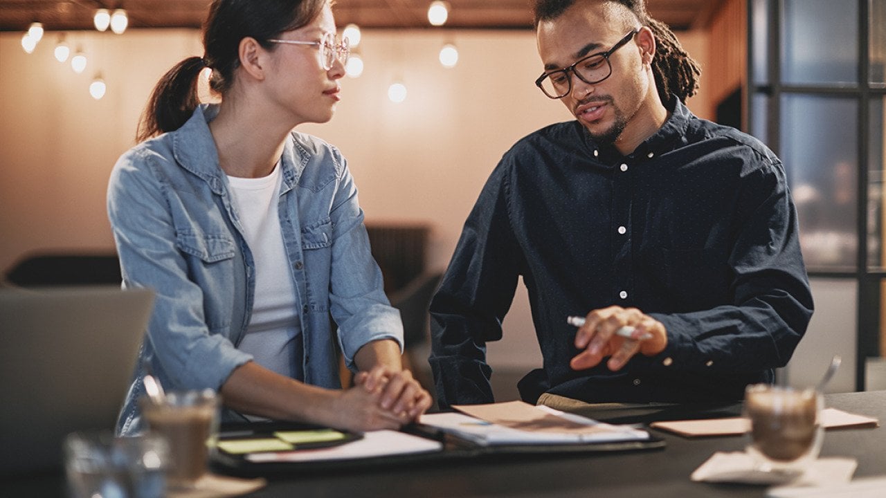 Two business people engaged in a discussion.