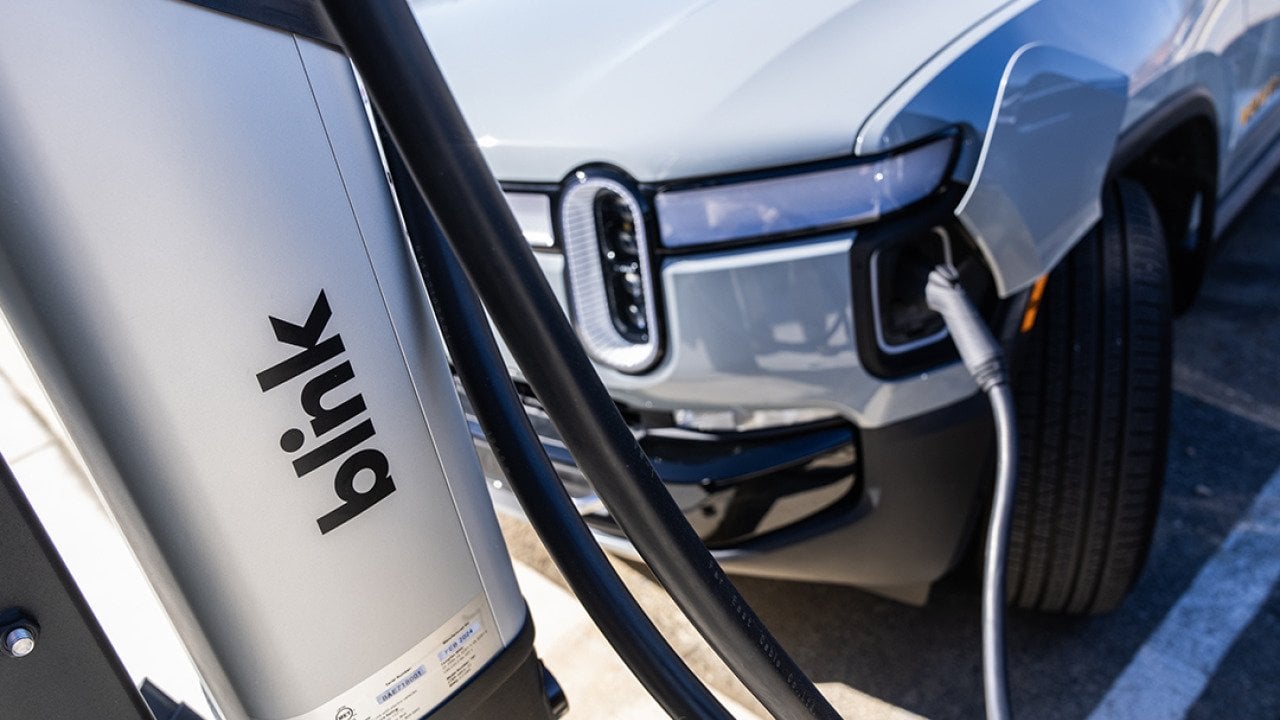 An EV charges from a Blink Charging station.