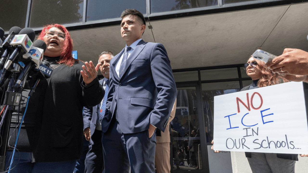 Andreina Mejia, mother of the Arleta High School student, a citizen, who was detained by immigration agents, speaks about their experience at a press conference announcing legal claims against the U.S. government. A few people stand beside her, including one woman holding a sign that reads, 