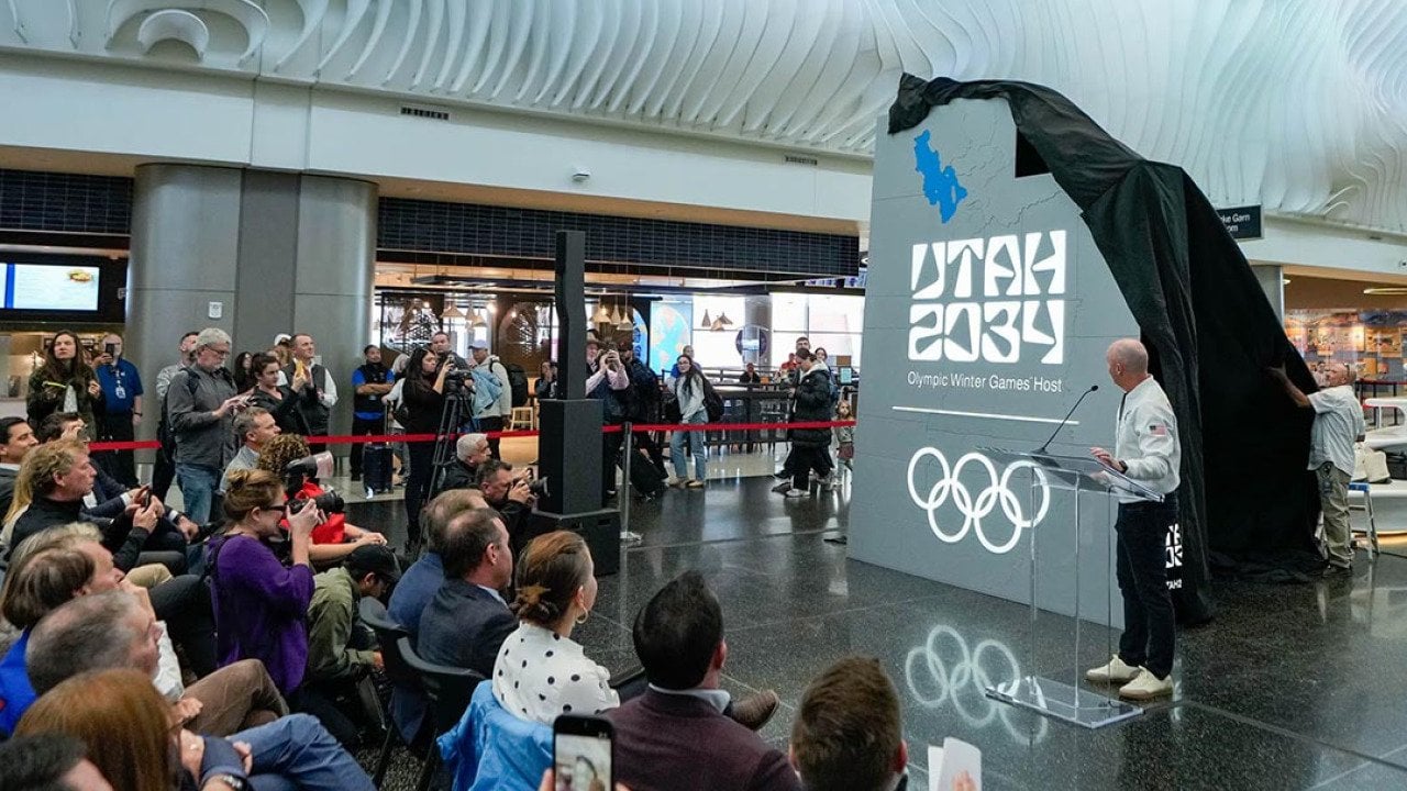 A crowd watches as organizers reveal a new name and logo — Utah 2034 — at Salt Lake City International Airport, as they count down les than 3,000 days until the Olympic Winter Games return to Utah.    