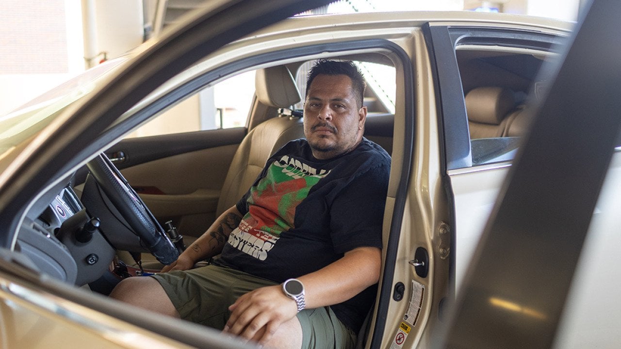 Edgar Rosales Jr. sits in the car where he lived for more than a year as a participant in the Safe Parking Program at Long Beach City College in Long Beach, Calif. There, he said, “you don’t have to be scared.”