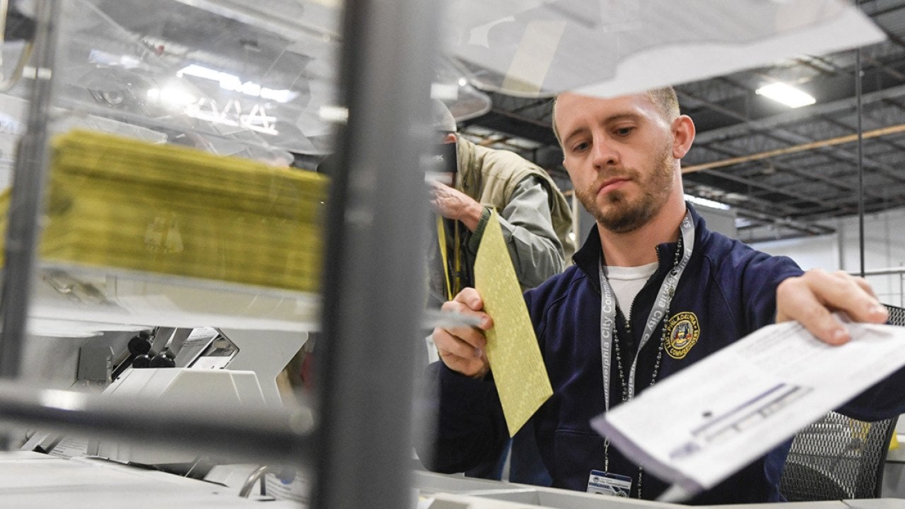 Poll workers demonstrate how ballots are received, processed, scanned, and securely stored on Election Day.