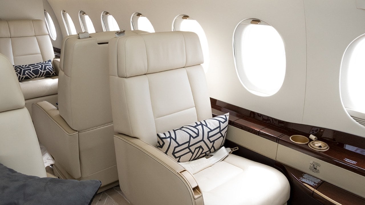 Cream-colored leather seats in a private business jet.