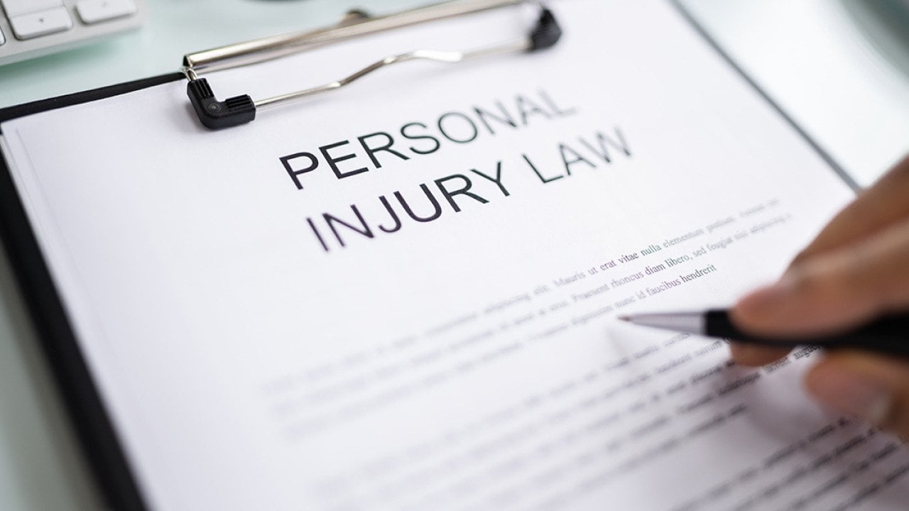 Personal Injury Law document on a clipboard.