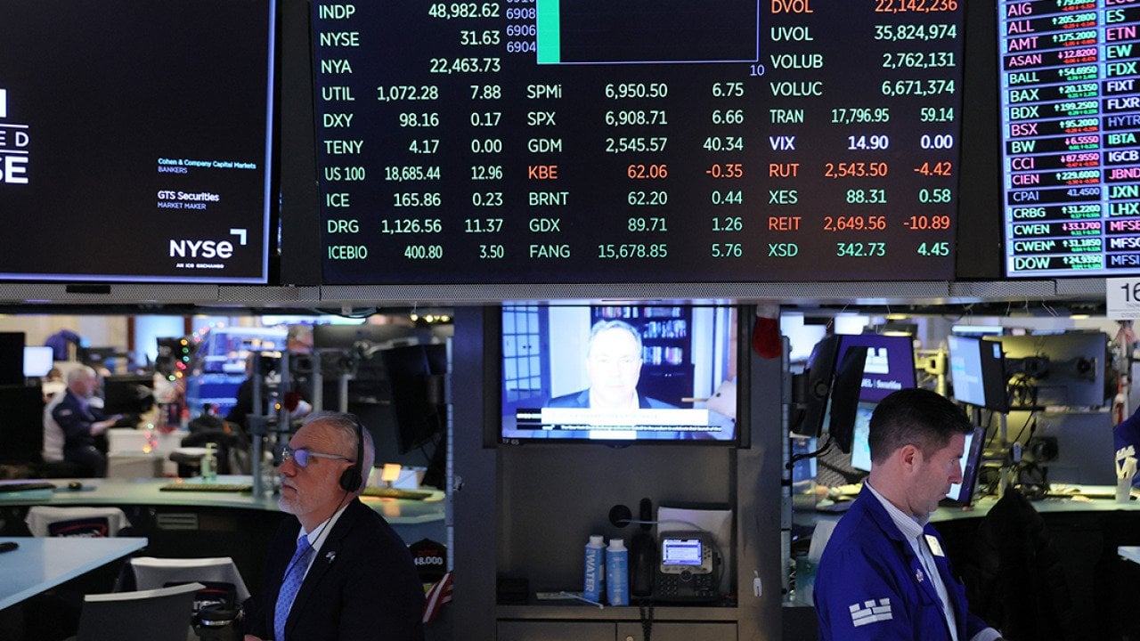 Traders work on the floor of the New York Stock Exchange during morning trading on January 06, 2026 in New York City. 