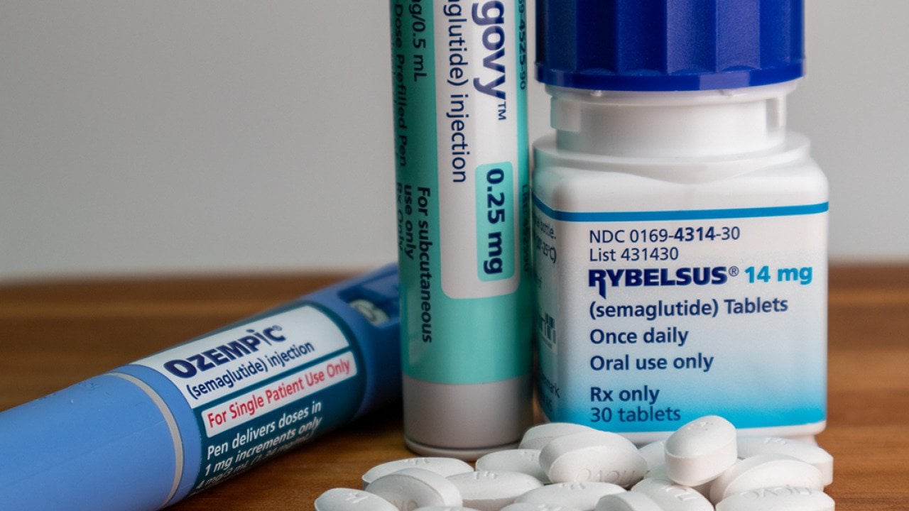 Ozempic, Wegovy, Rybelsus semaglutide medications on a table.