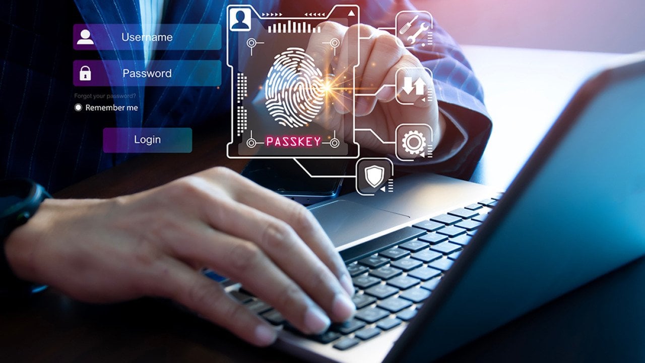 Person using a laptop illustrated with graphics of digital user login interface.