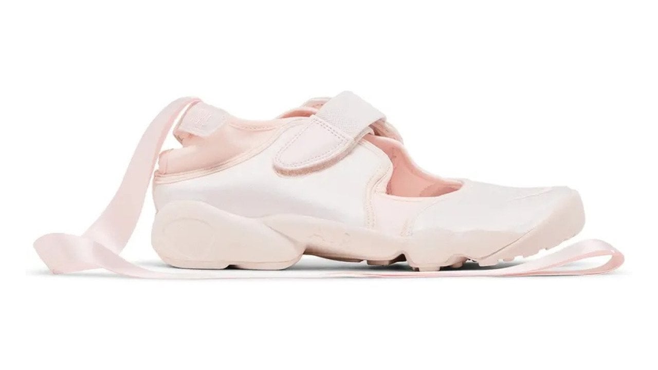 A side view of a Nike Air Rift ballerina shoe in light pink colorway.