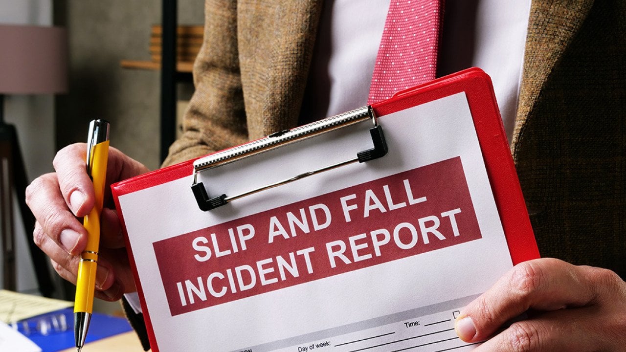 A slip and fall incident report on a clipboard.