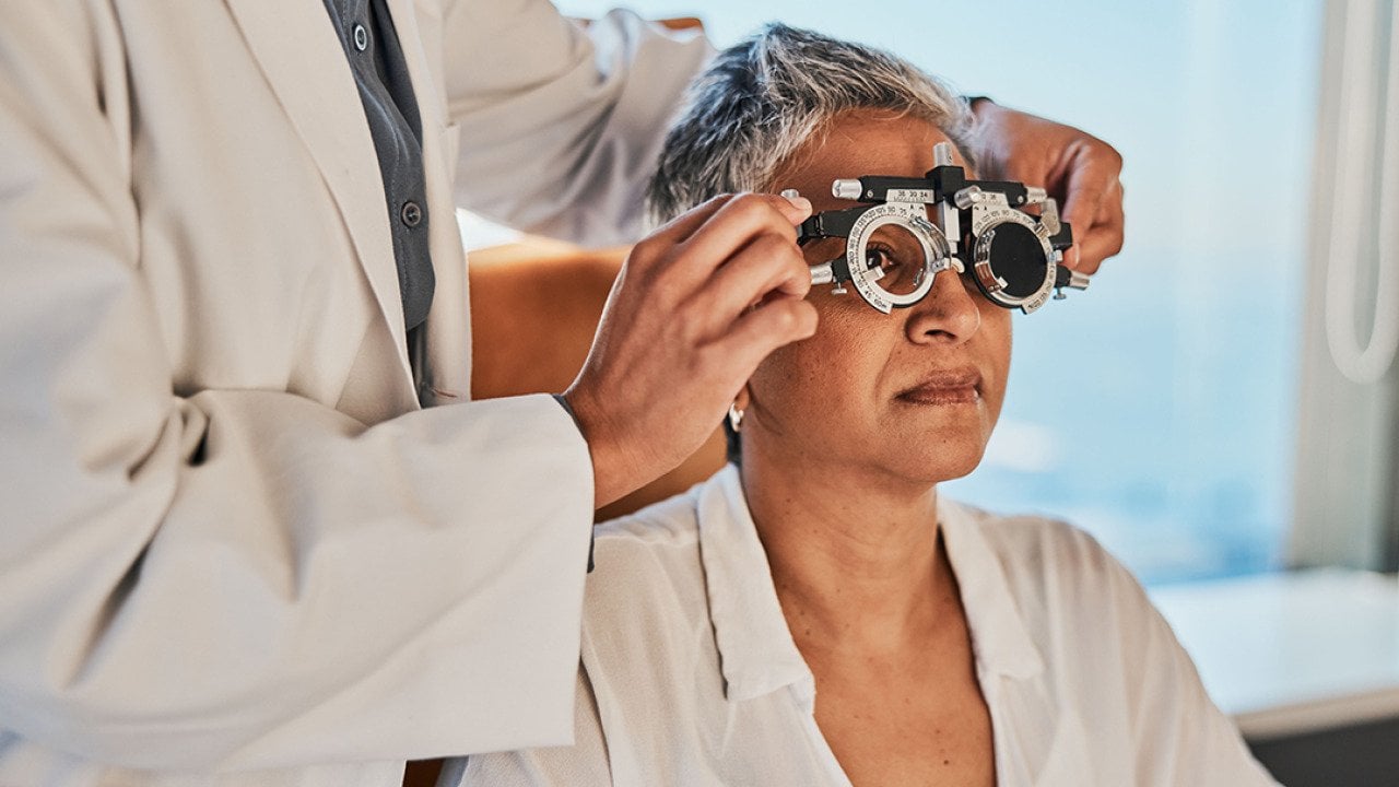 A senior woman getting a vision test for eyeglasses.