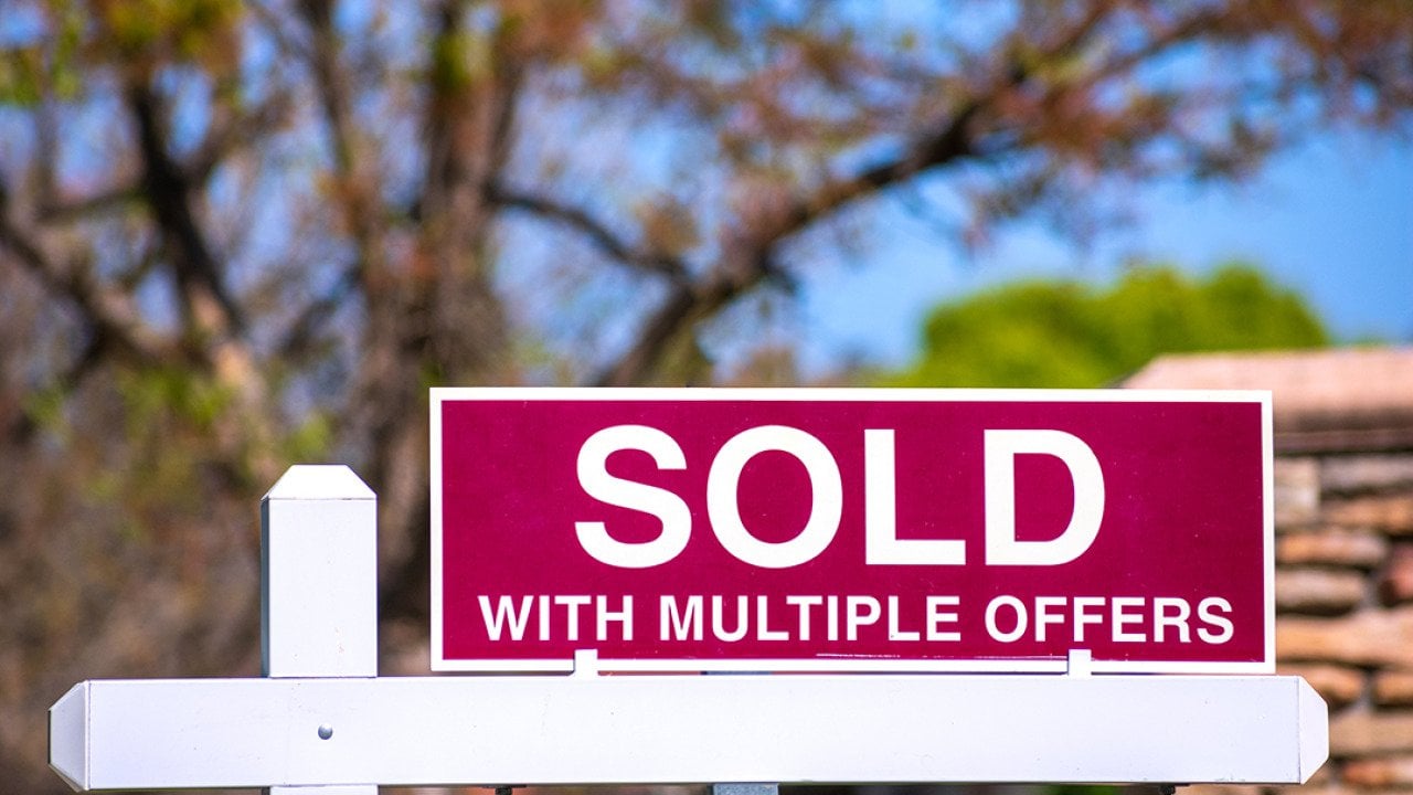 A 'sold with multiple offers' sign for a property.
