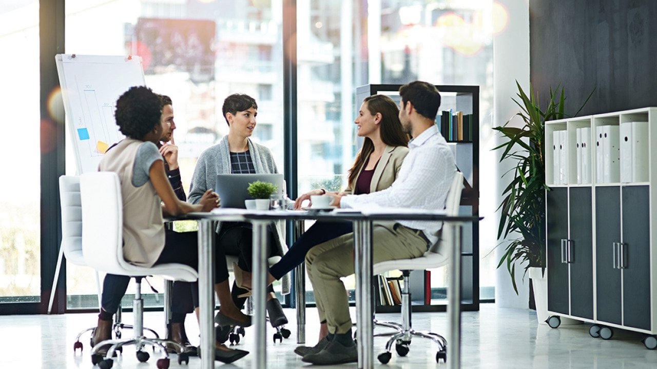 A group of businesspeople having a meeting together in a modern office
