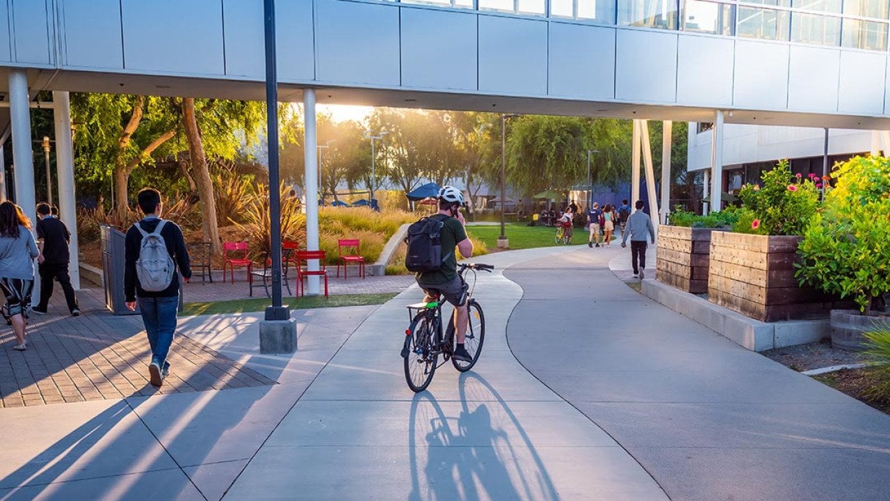 People walking and cycling around the Google headquarters.