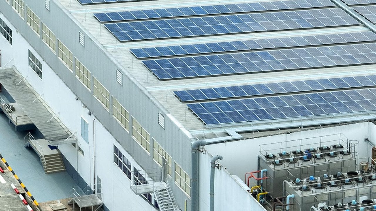 A warehouse building with solar panels on the rooftop.