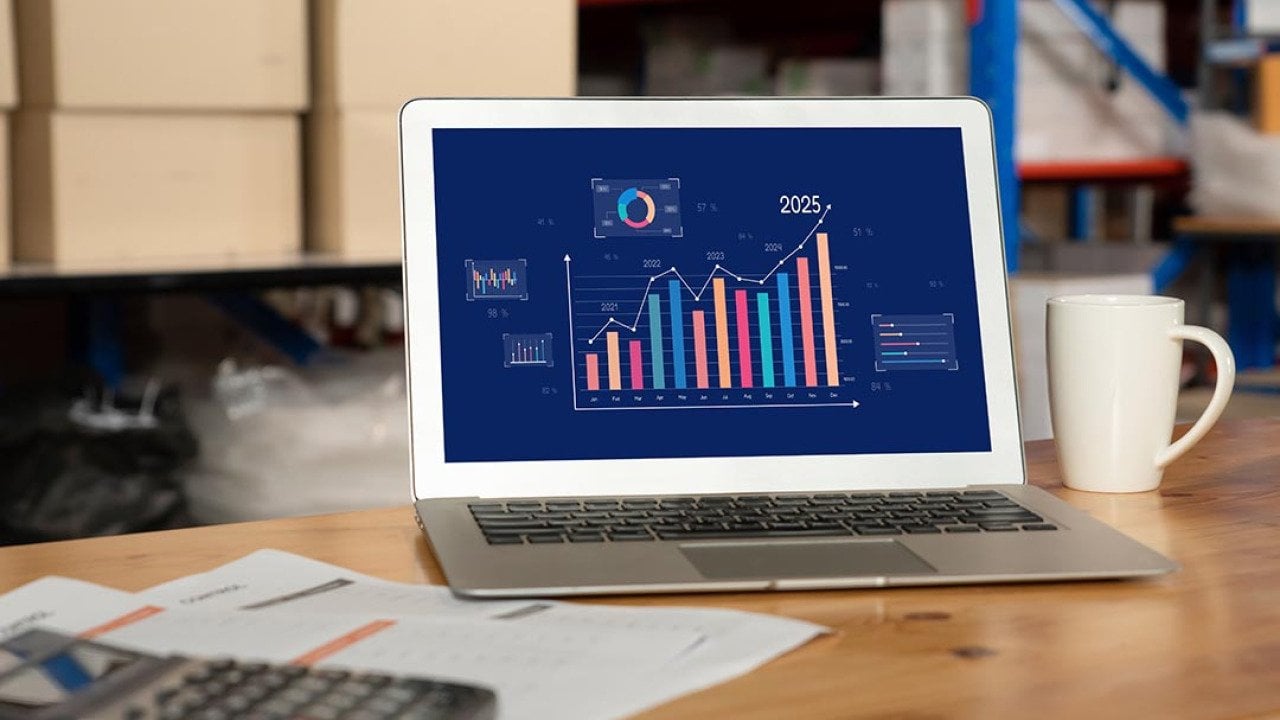 Data dashboard displayed on a laptop inside a warehouse.