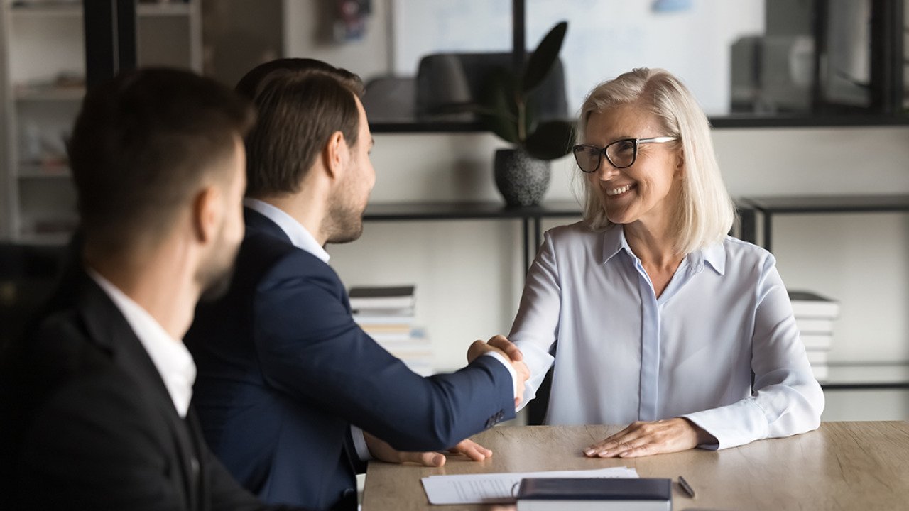 Business partners shaking hands during a meeting.