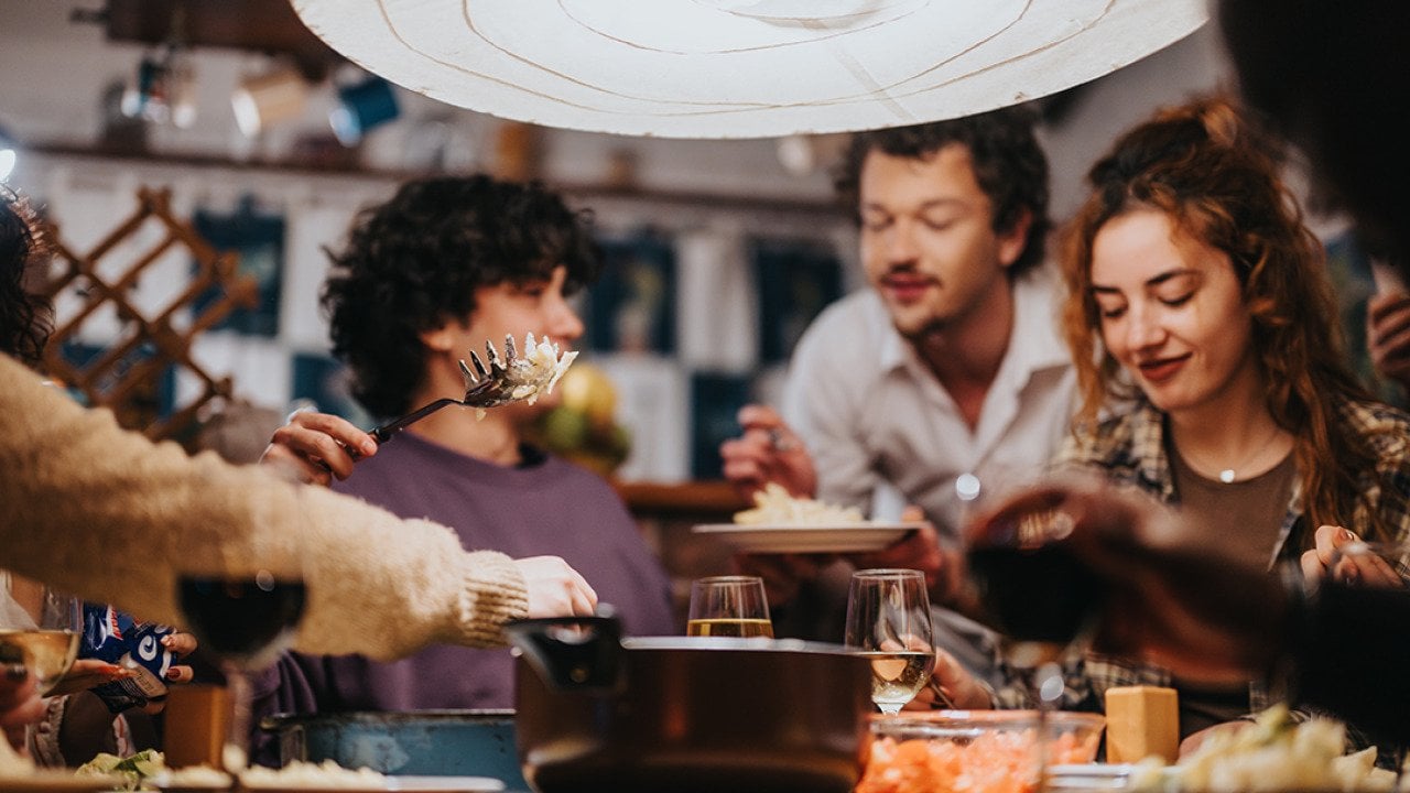 A group of friends having a dinner party.