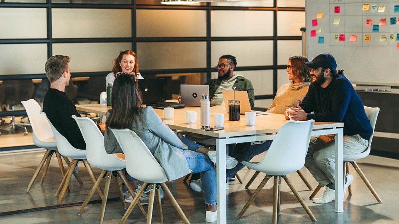 A business team brainstorming in a modern office.