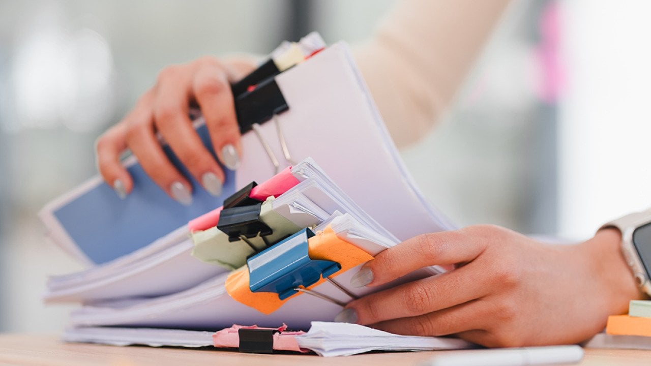 Person organizing sets of documents.