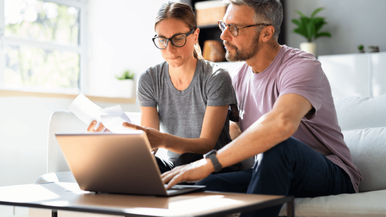 Couple doing taxes on a computer.