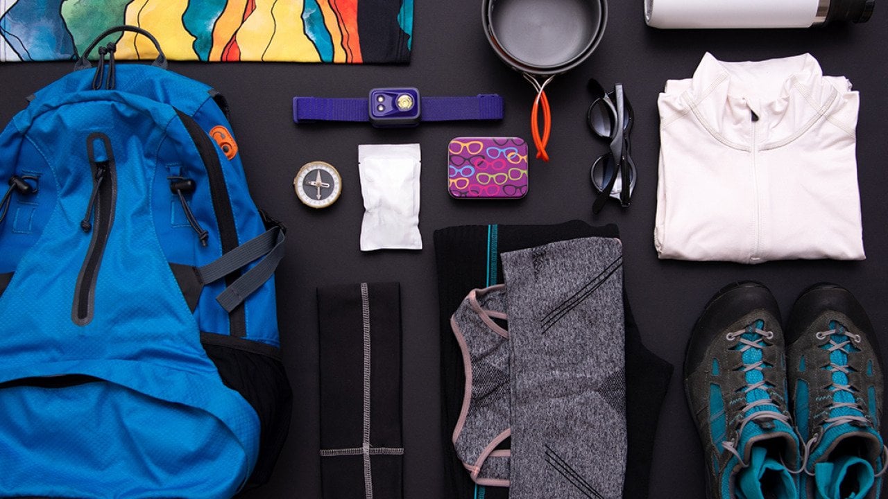 A flat lay set of hiking gear and essentials.