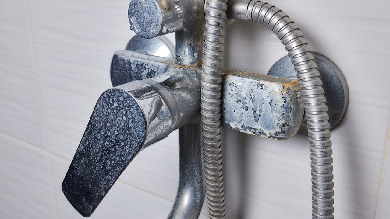 An old tap aerator with marks of hard water.