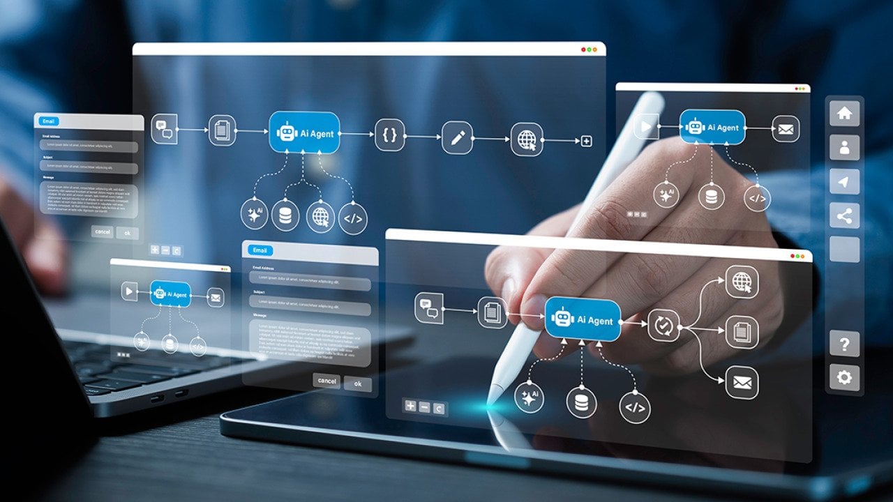 AI workflow automation graphics over a person using a laptop and digital tablet at work.