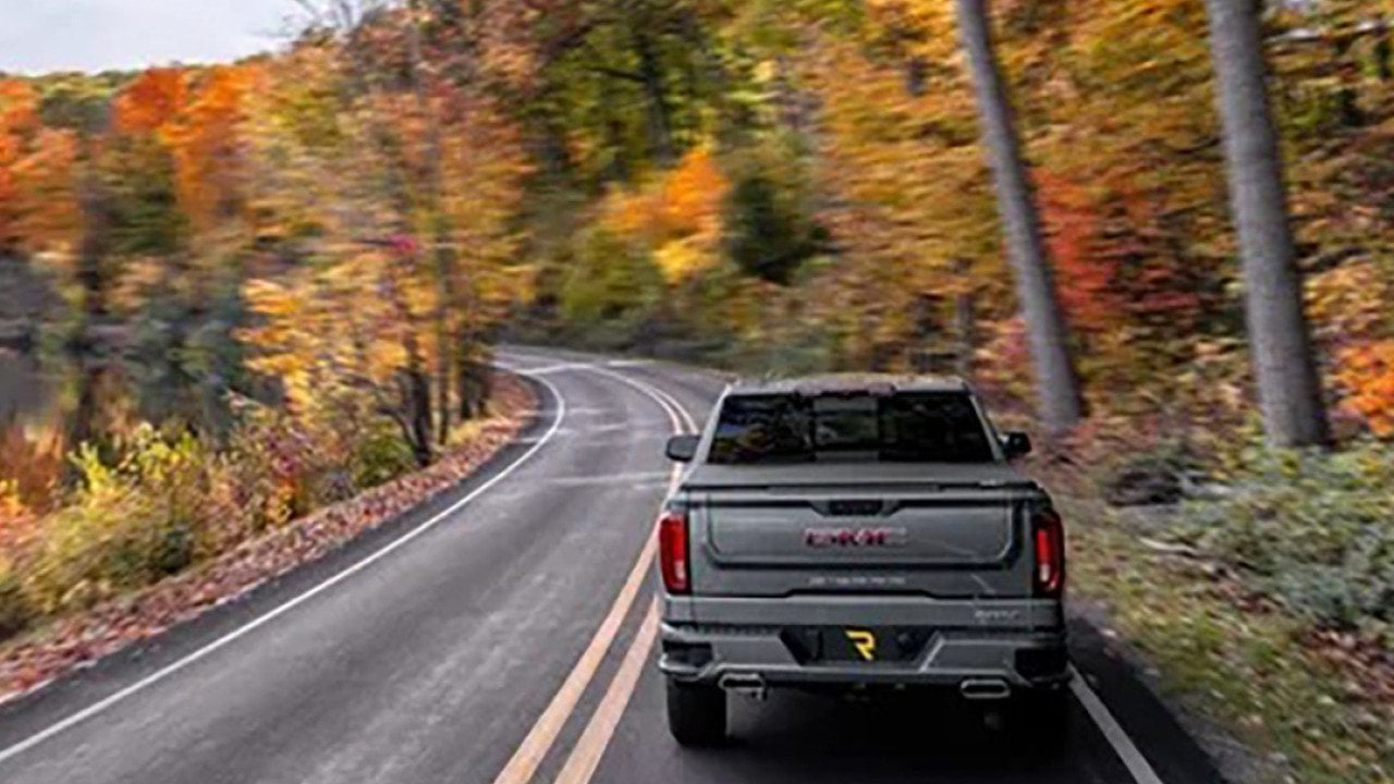 A truck driving down a highway.