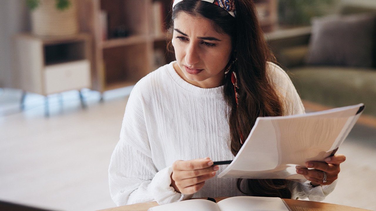 A person going through paperwork at home. 