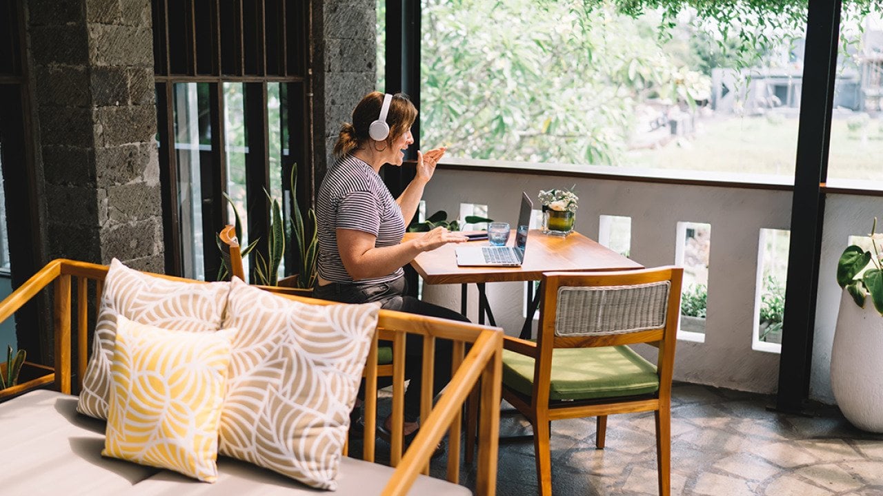A freelancer working remotely from a home balcony.